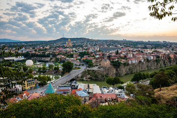 Aerial panoramic view of Tbilisi city center at summer sunrise