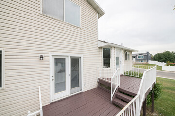 Outdoor veranda with wooden flooring and white railings