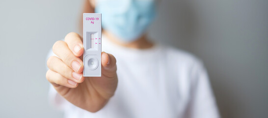 woman holding Rapid Antigen Test kit with Negative result during swab COVID-19 testing. Coronavirus Self nasal or Home test, Lockdown and Home Isolation concept