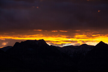 Dramatic sunset with clouds over desert canyon