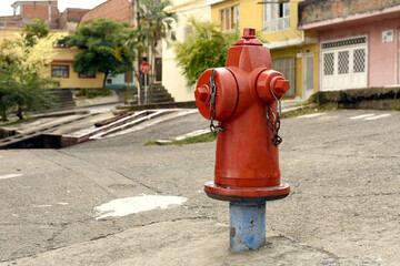 Fototapeta na wymiar Towering red fire hydrant protecting the homes in your neighborhood.
