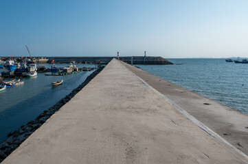 Fototapeta premium A straight cement road leading to the wharf