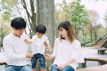 公園で両親と遊ぶ子供
