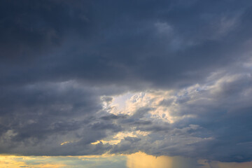 Dark sky with storm clouds before sunset in late summer