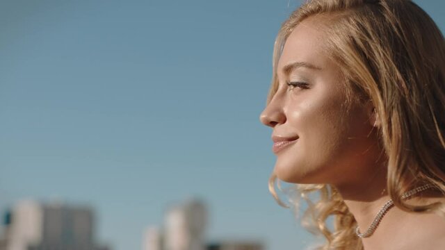 beautiful stylish woman at glamorous rooftop party celebration smiling with confidence enjoying luxury lifestyle looking at city from roof at sunset 4k