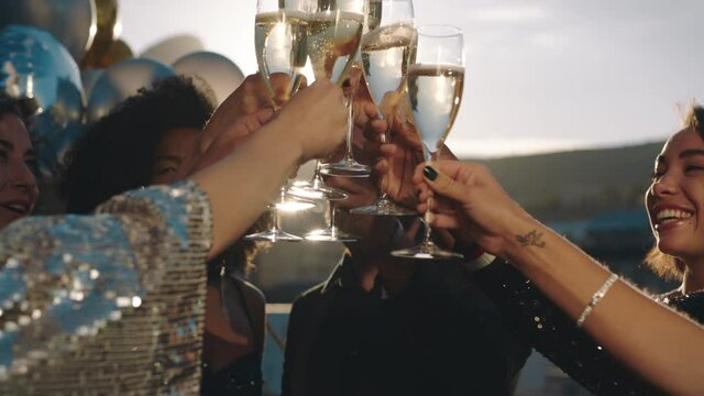 stylish friends celebrating making toast to glamorous party event drinking champagne at formal social gathering enjoying rooftop celebration at sunset 4k