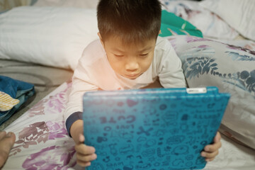 asian chinese boy playing smartphone, kid use phone and play game, addicted game and cartoon
