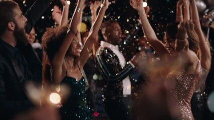 fun party friends celebrating new years eve dancing throwing confetti enjoying glamorous celebration wearing stylish fashion social gathering on rooftop at night 4k