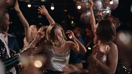 happy group of friends celebrating new years eve party dancing throwing confetti enjoying glamorous celebration wearing stylish fashion social gathering on rooftop at night 4k - Powered by Adobe