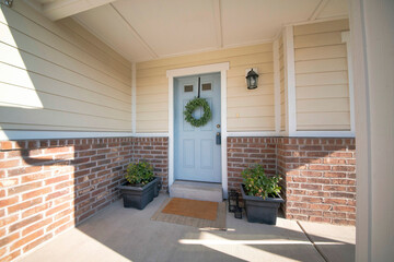 Decorated entrance of a house with potted plants and lanterns