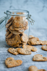 Homemade heart shaped healthy crackers in glass jar