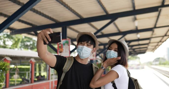 Couple selfie on smartphone at train station