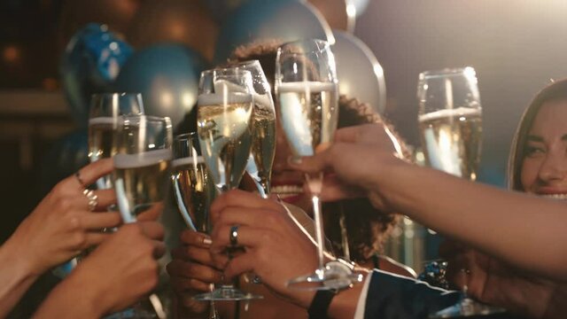 happy group of friends celebrating making toast to glamorous party event drinking champagne wearing stylish fashion at formal social gathering enjoying rooftop dance celebration at sunset 4k