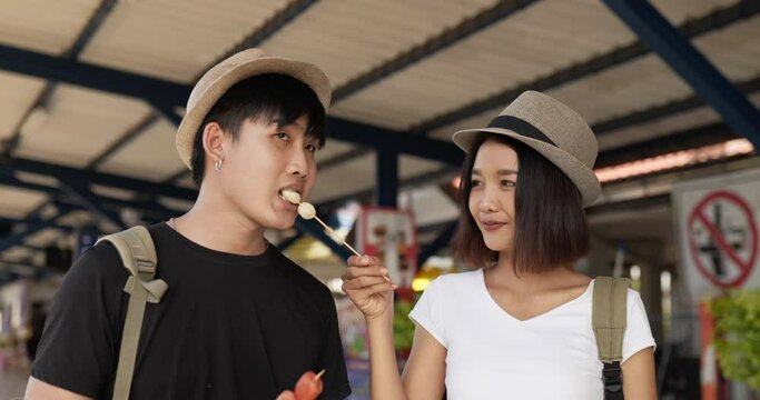 Couple Eating Meatball At Train Station