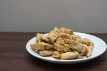 Malaysia delicacy Fish Crackers on a white plate (Keropok Lekor)