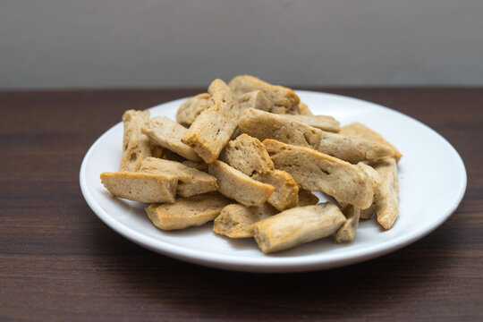 Malaysia delicacy Fish Crackers on a white plate (Keropok Lekor)