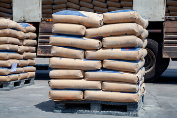 Cement bags are placed on pallets and stored in warehouses, Cement bags for construction, Cement...