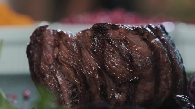 Close-up of Juicy fried beef steak filet mignon on plate with herbs and spices.  delicious dish for dinner. Cooking meat on the grill.