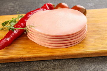 Sliced pork sausages stack over board