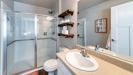 Pano Interior of a full bathroom with shelves and cabinet