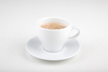 small cup of hot chocolate on a white plate in a white cup