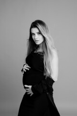 Beautiful pregnant young woman in studio