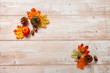 Festive autumn decor from pumpkins, leaves and acorns on a wooden background. Concept of Thanksgiving day or Halloween. Flat lay autumn composition with copy space.