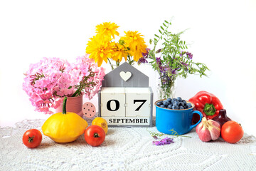 Calendar for September 7 : the name of the month in English, cubes with the numbers 0 and 7, ripe...