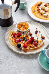 Breakfast crepes with coffee cups pot