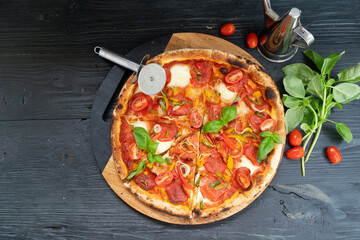 Pizza with salami and tomatoes