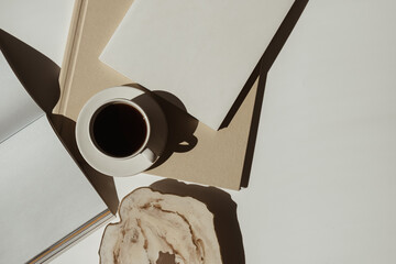 Aesthetic luxury bohemian minimalist workspace desk. Blank paper sheet notebook, cup of coffee,...