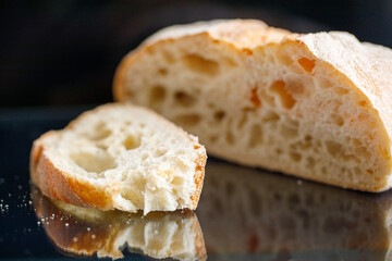 sliced white bread on dark glass background
