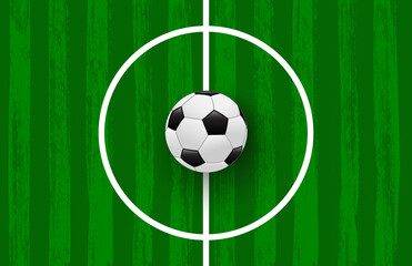 Green football field made of brush stroke with realistic soccer ball. Vector banner template for sport tournaments and competitions.