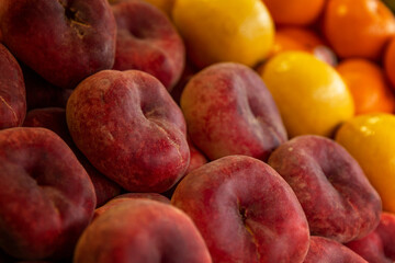 Juicy nectarines on the market counter. Vitamins and health from nature. Side view. Close-up.