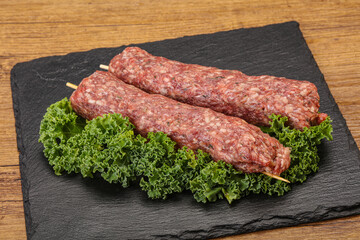 Raw minced beef kebab skewer