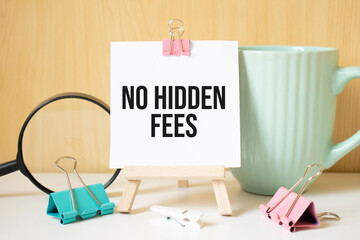 No Hidden Fees text written on black notebook with magnifying glass and a pen. Business and...