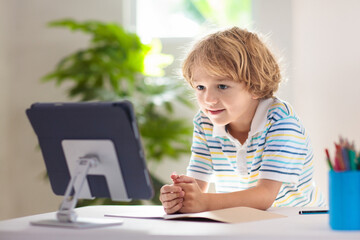 Online remote learning. School kids with computer.