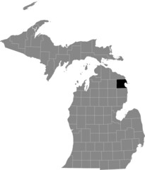 Black highlighted location map of the Alpena County inside gray map of the Federal State of Michigan, USA