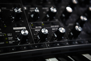 Analog synthesizer device. Professional audio equipment for electronic music production in sound recording studio.  - obrazy, fototapety, plakaty
