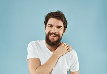 Obraz premium Man in a white t-shirt happy facial expression blue background