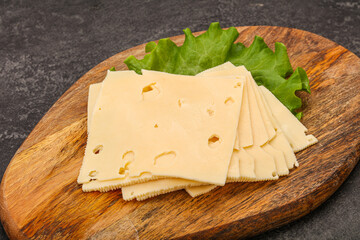 Sliced yellow cheese over board