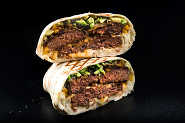 Grilled beef burgers in pita bread with cheese and arugula leaves