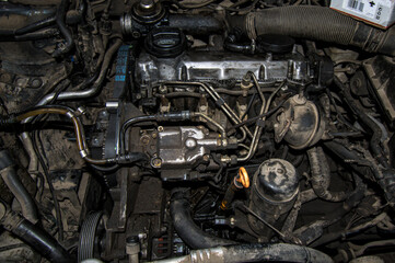 Open real car engines in the repair phase in a car mechanic shop