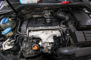 Fototapeta premium Open real car engines in the repair phase in a car mechanic shop
