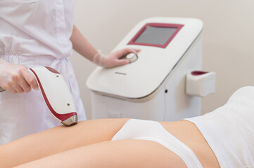 A woman in a professional beauty salon removes unwanted vegetation in the bikini area using laser hair removal