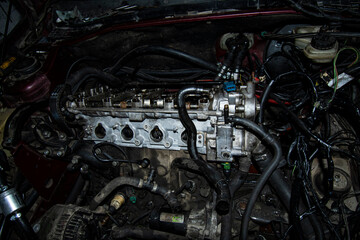 Fototapeta na wymiar Open real car engines in the repair phase in a car mechanic shop