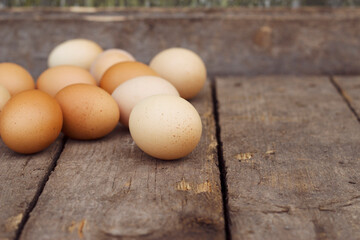 Brown chicken eggs on the old wooden table. Rural food  for cooking.