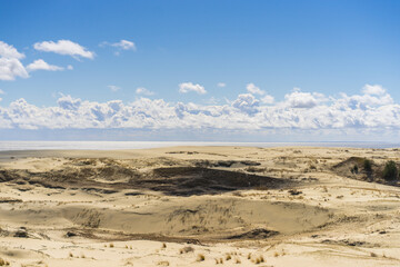 Fototapeta na wymiar Coast of the Baltic Sea. Sand dunes with clouds. Typical Baltic beach landscape.