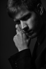 Young confident caucasian man in suit in black and white. Business concept