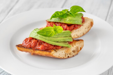 Bruschettas with tomato spread and avocado